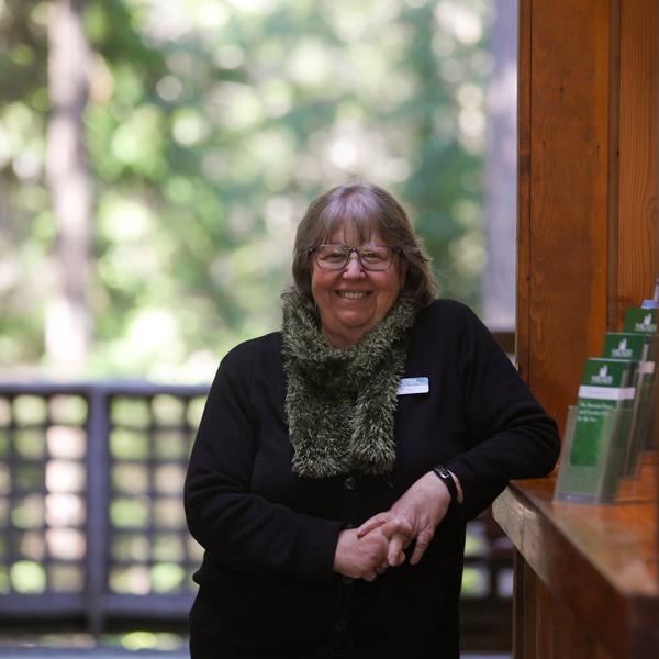 Woman standing and welcoming visitors